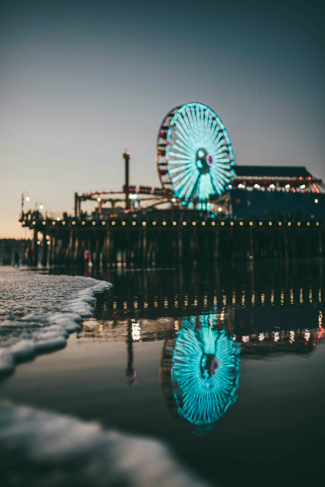 blue and white ferris wheel near body of water during daytime