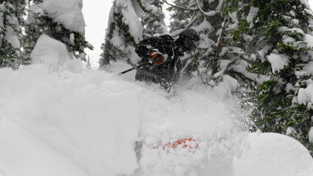 a man riding skis down a snow covered slope