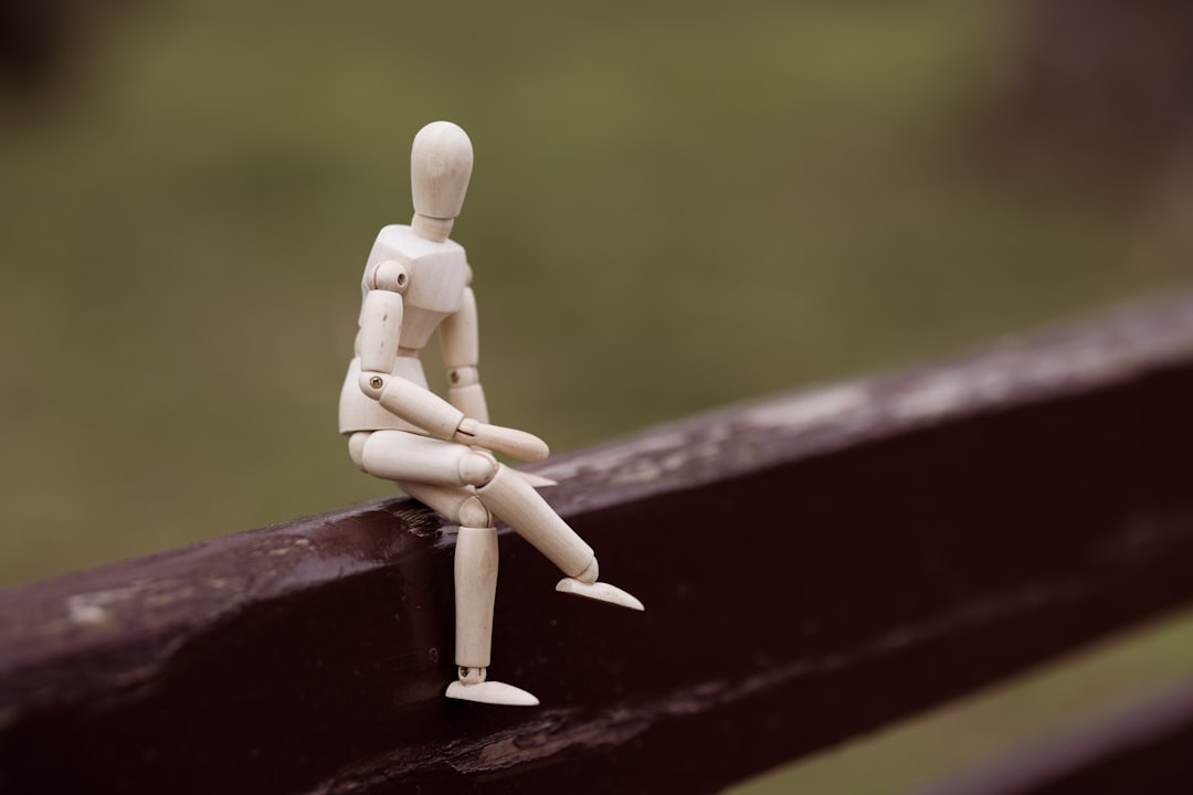 brown wooden figurine on red wooden surface