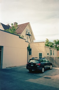 A freshly poured concrete driveway leading up to a cozy suburban home.