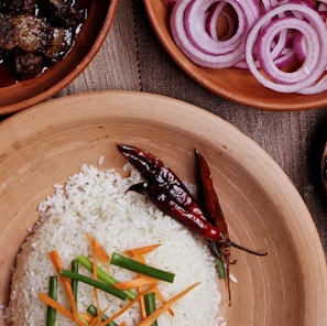 cooked rice on brown wooden bowl