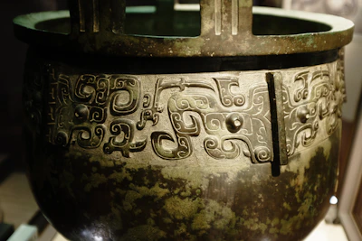 Close-up of a beautifully aged bronze pot with intricate patterns reflecting Bronze Age artistry.