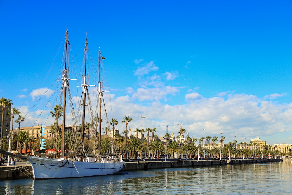 white sail boat on body of water during daytime