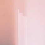 Close-up of a smooth wall freshly painted in a warm, inviting shade.