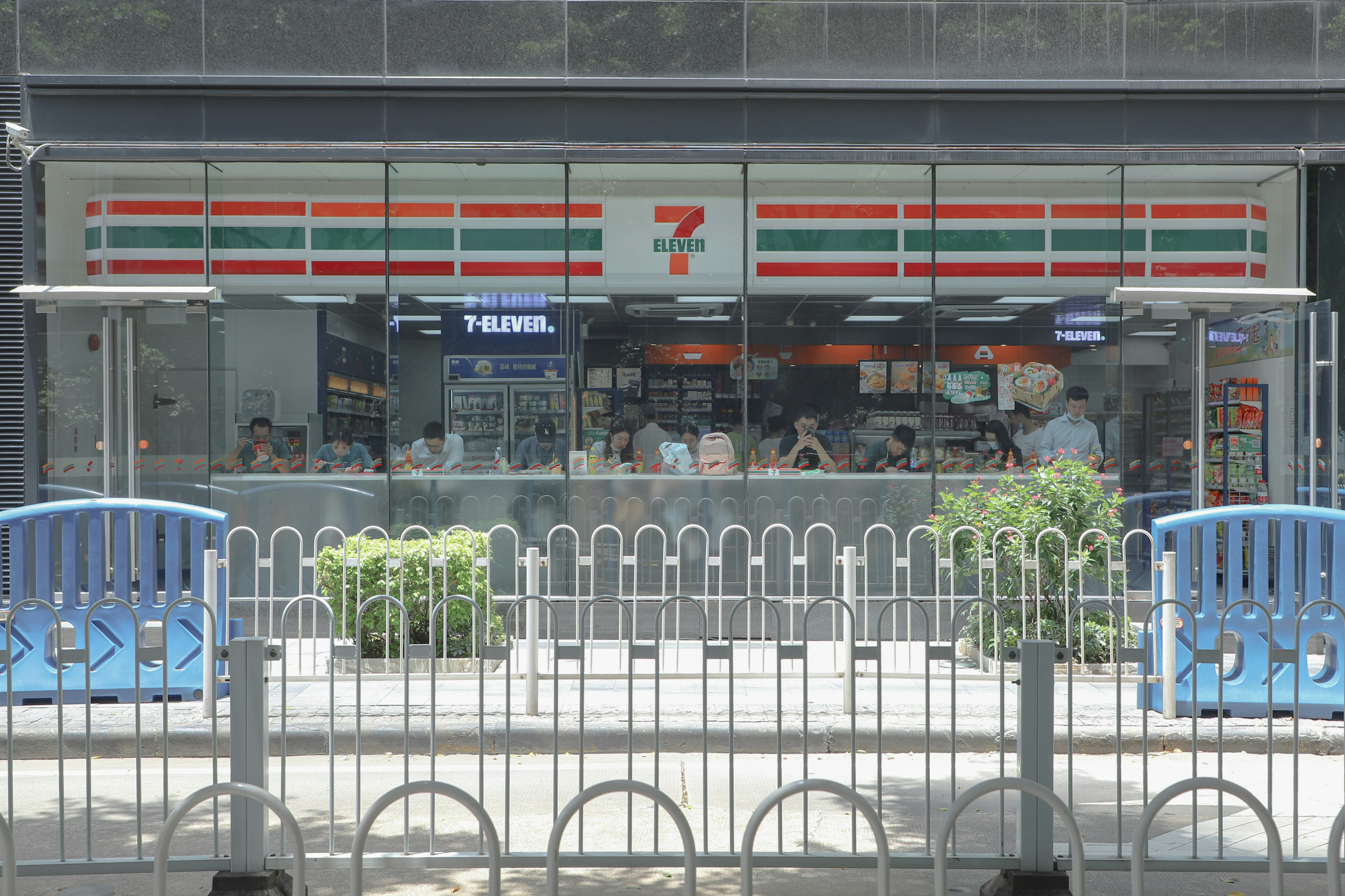 white metal fence near green plants during daytime