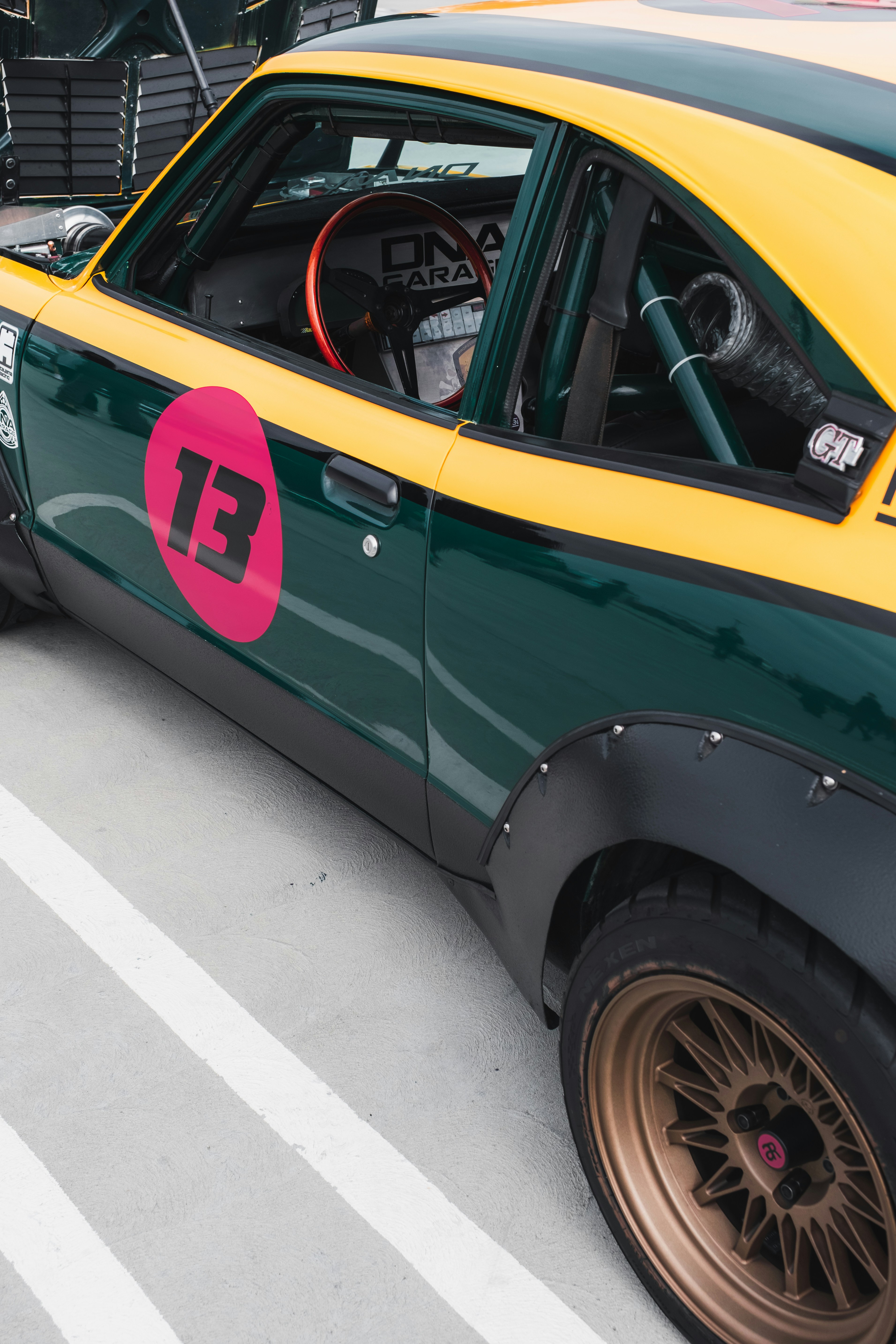 green and black car on gray concrete floor