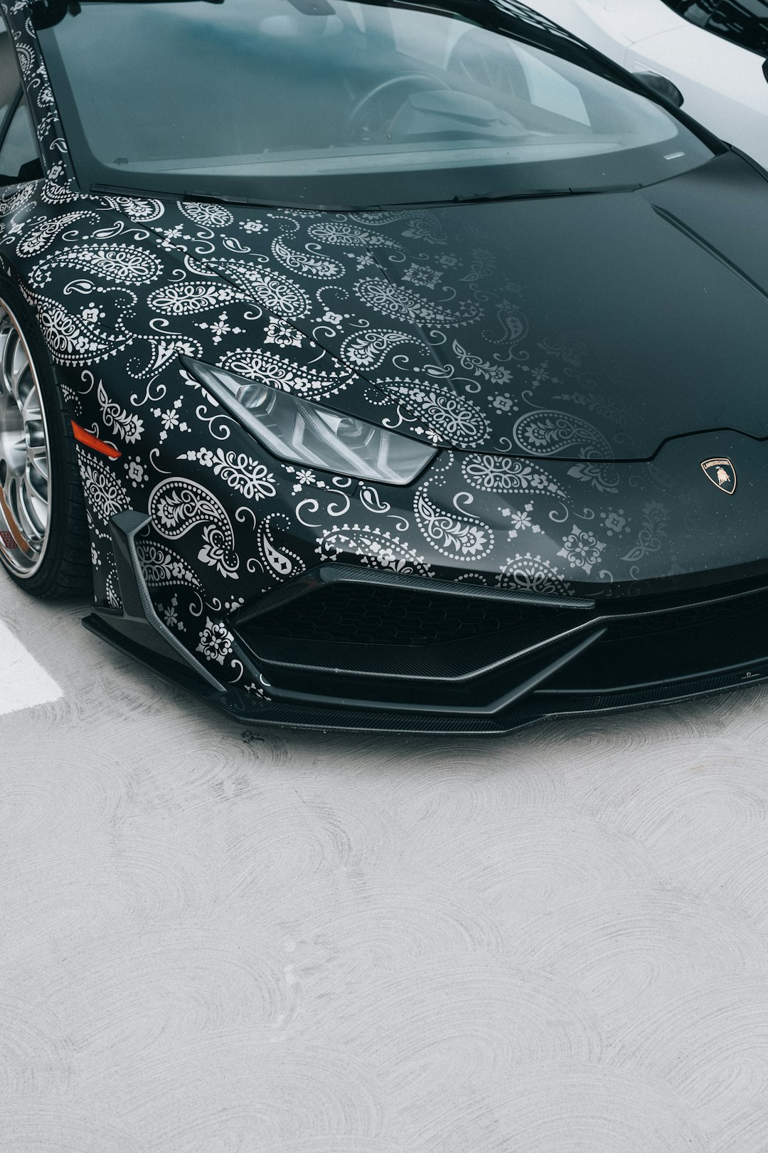 black ferrari car on white floor