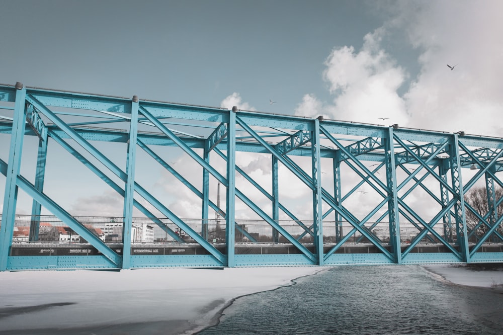 blue metal bridge under blue sky during daytime