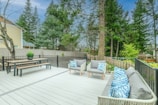 white wooden bench on wooden deck