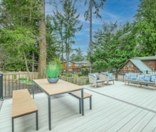 brown wooden table and chairs on wooden deck