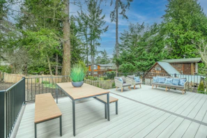 brown wooden table and chairs on wooden deck