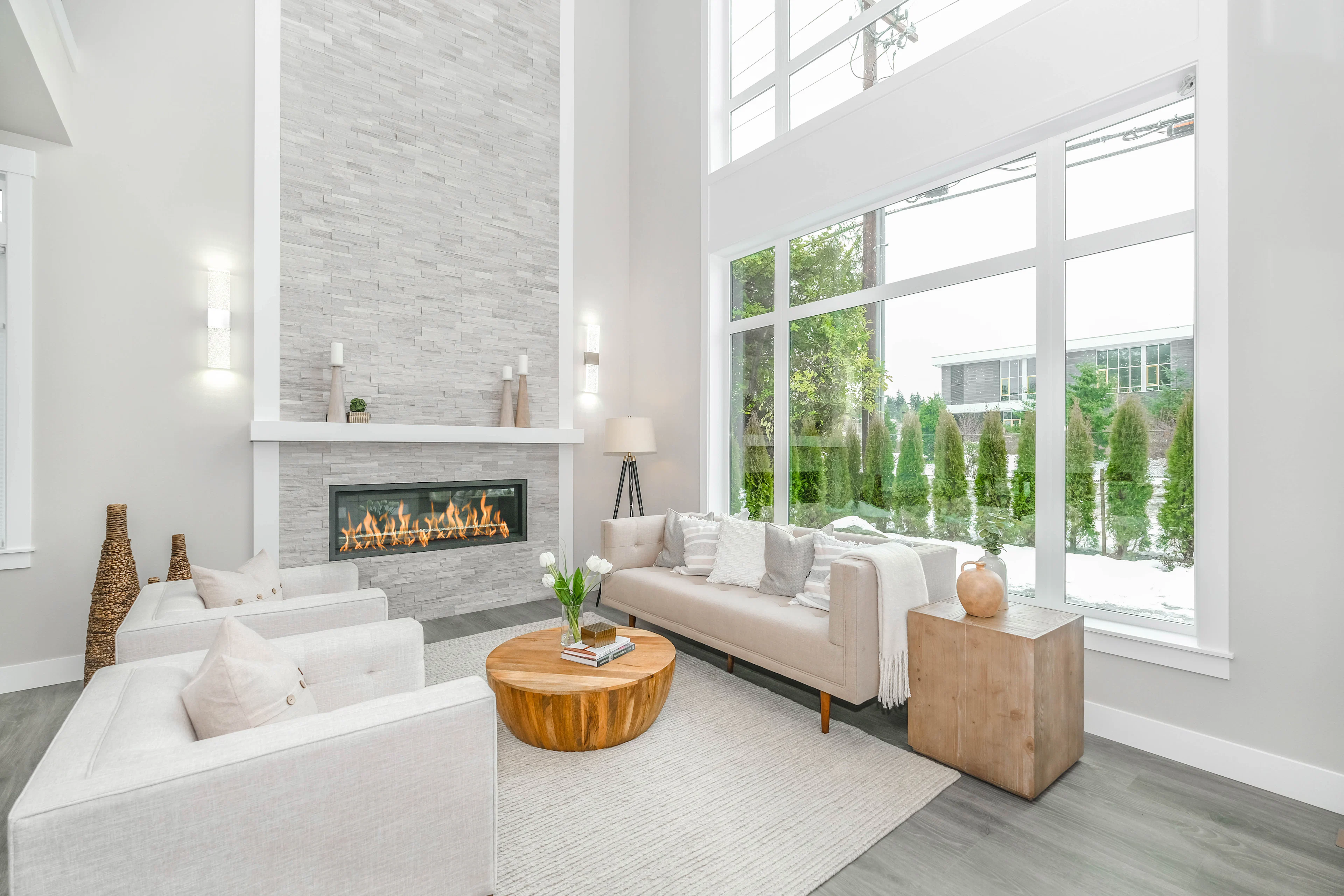 White sofa beside a floor-to-ceiling window