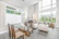 Modern living room with bright natural light and stylish Mediterranean decor.