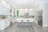 A modern kitchen with sleek cabinets and a large island, showcasing a bright and inviting space.