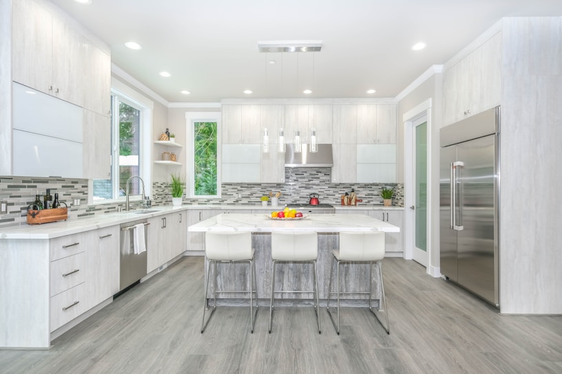 A beautifully remodeled kitchen featuring sleek cabinetry, modern lighting, and a spacious island.