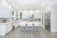 A modern kitchen with sleek cabinets and a large island, showcasing a bright and inviting space.