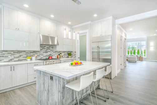 Remodeled kitchen with backsplash and island.