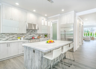 white wooden kitchen cabinet near white wooden kitchen cabinet