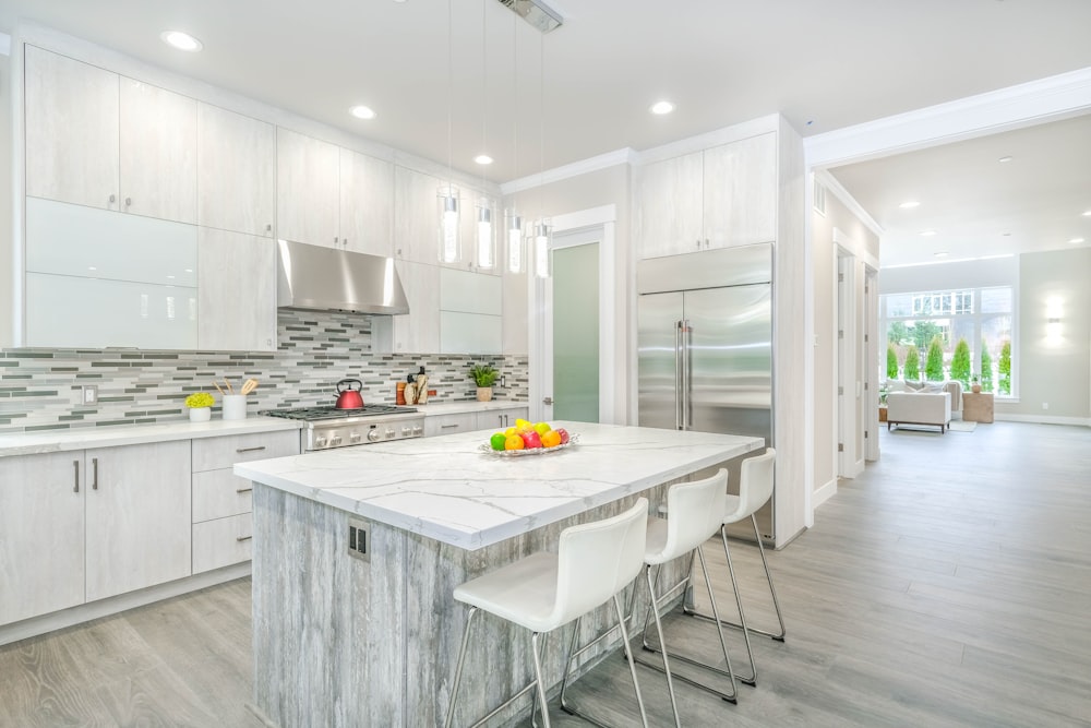 white wooden kitchen cabinet near white wooden kitchen cabinet