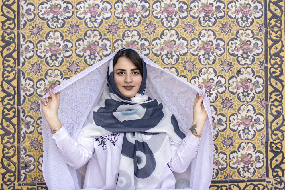 a woman in a headscarf poses for a picture