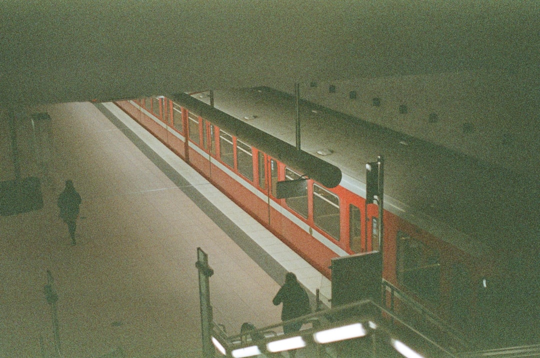 red and white train on train station