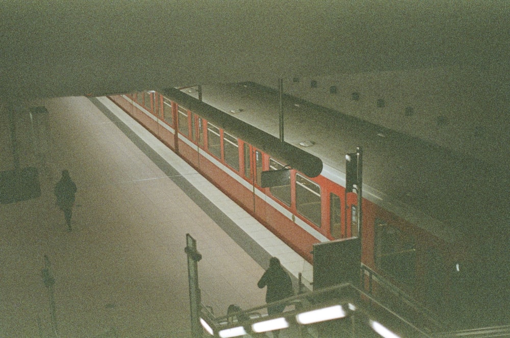 red and white train on train station