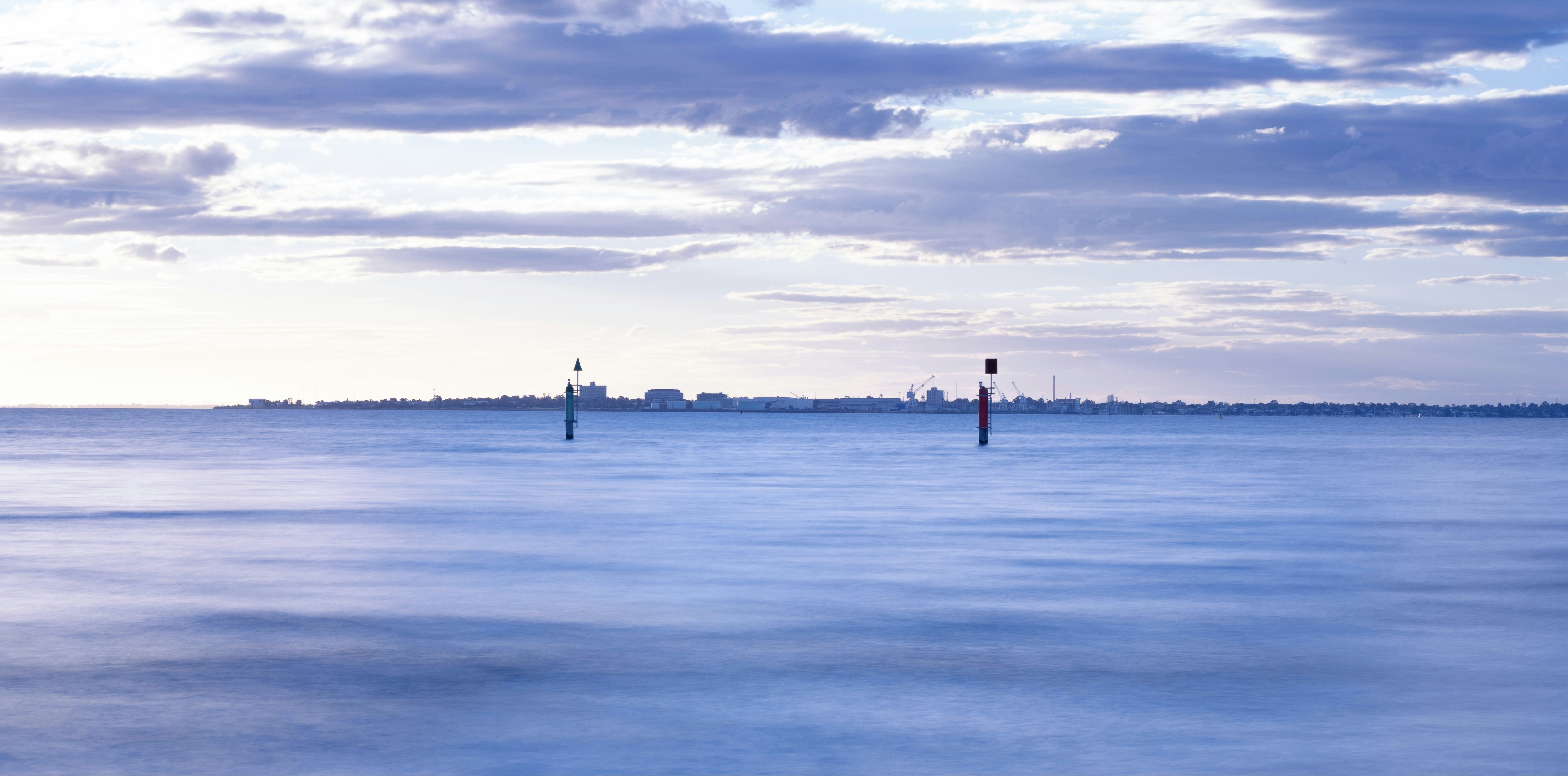 person standing on sea shore during daytime