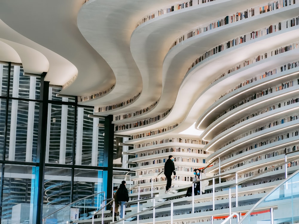 people walking on white concrete building