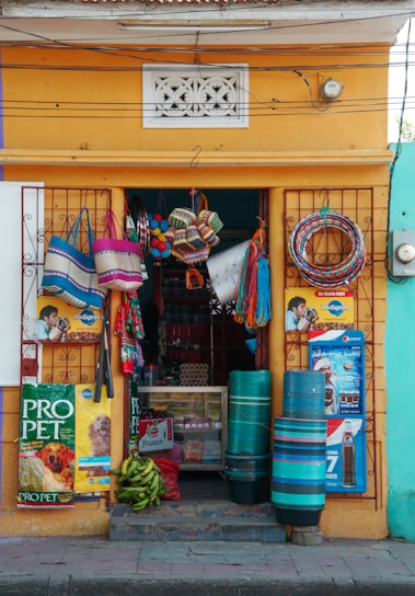 A bright, welcoming storefront of Baidya Stores with fresh produce displayed outside.