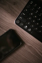 black and white keyboard on brown wooden table