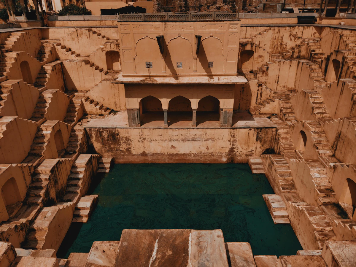 An old stepwell beside water in India