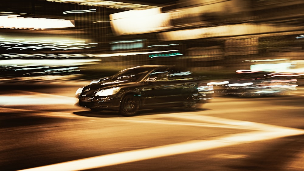 black sedan on road during night time