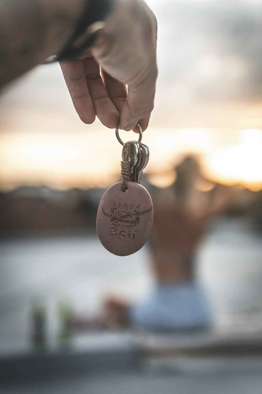 person holding heart shaped silver pendant