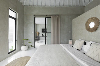 white bed near glass sliding door