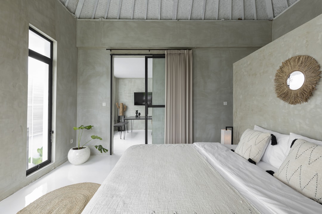 white bed near glass sliding door,