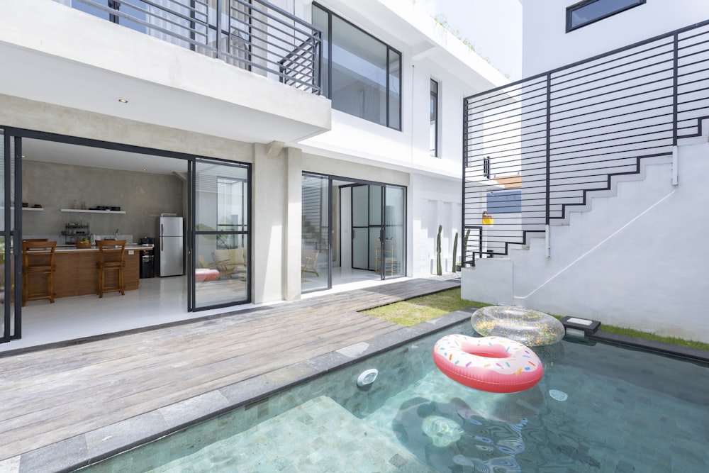 red inflatable ring on swimming pool