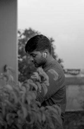 A serene landscape with a person meditating, wearing earbuds.