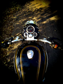 A close-up of a rider’s gloved hand gripping the throttle on a sunny day.