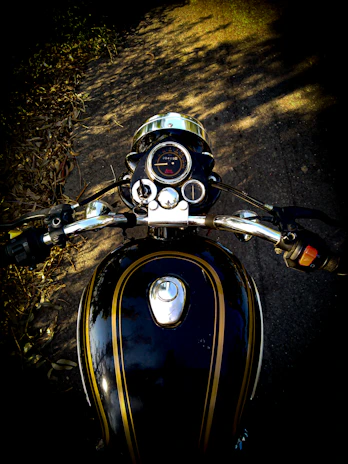 A close-up of a rider’s gloved hand gripping the throttle on a sunny day.