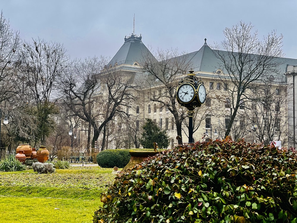 a large building with a clock in front of it