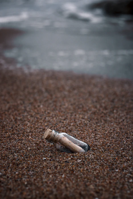 white and brown wooden tube on brown sand