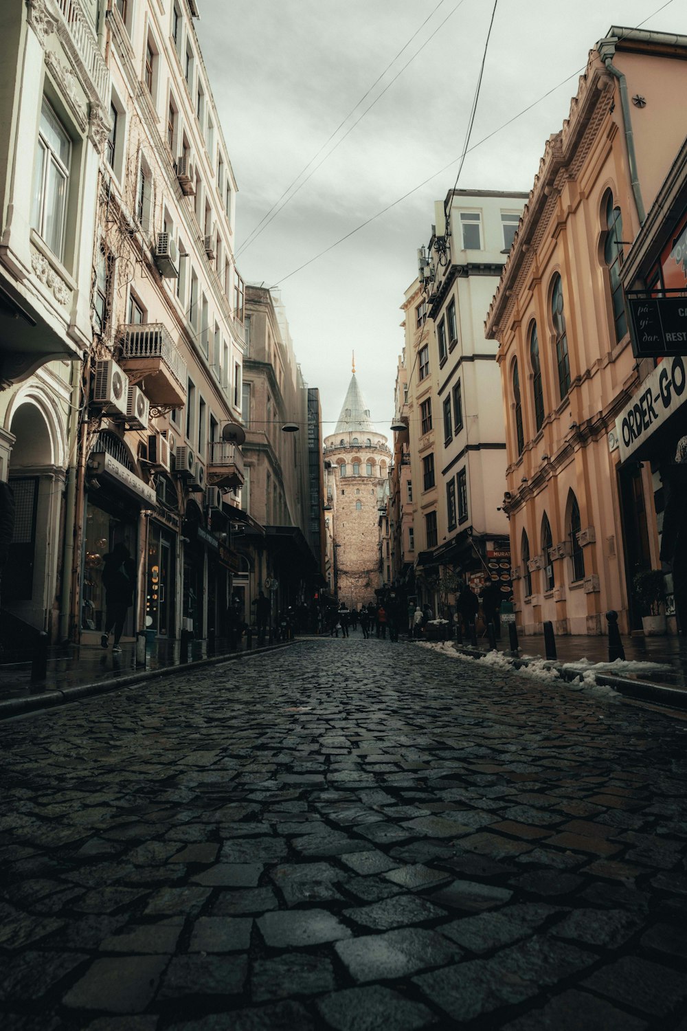 empty street between concrete buildings during daytime