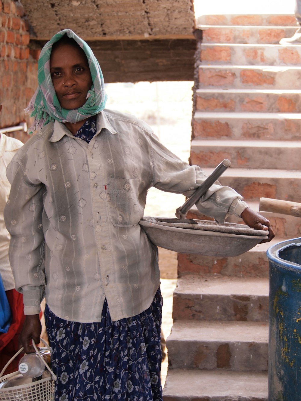 woman in gray jacket holding a tray