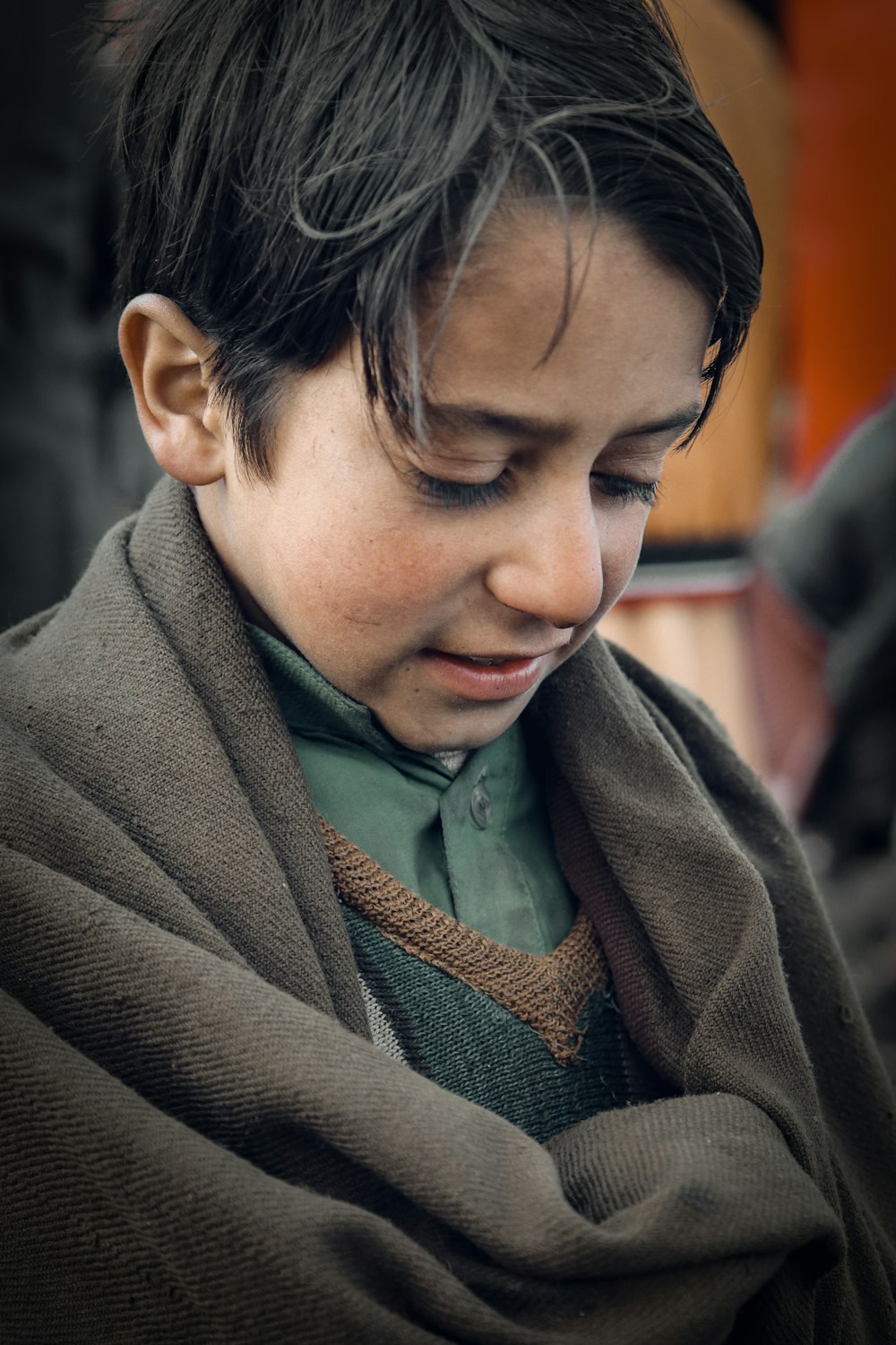 man in brown coat looking down