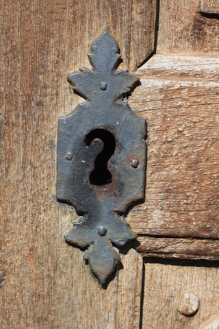 A close-up of a mysterious locked door with an antique keyhole.