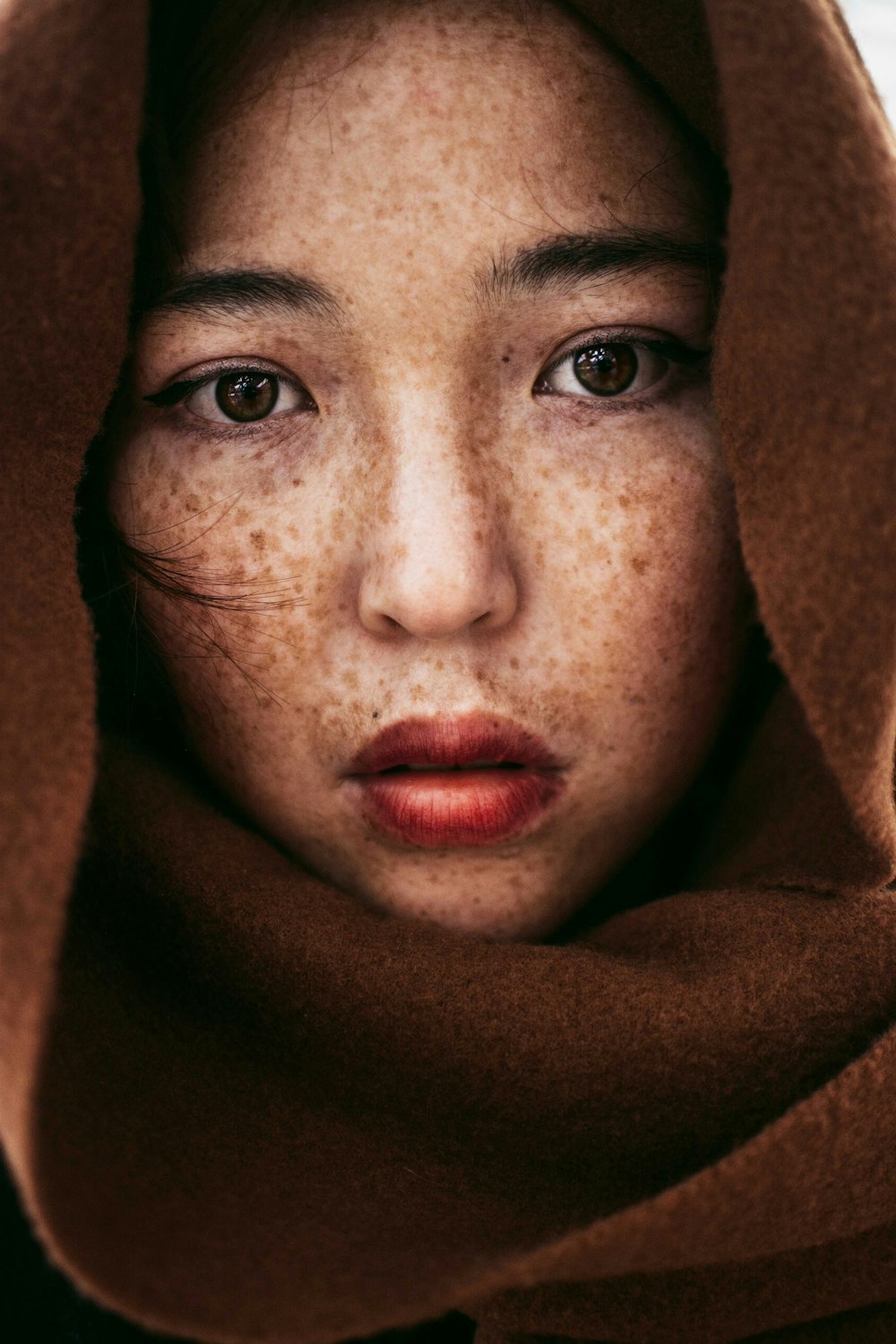 woman in brown hijab taking selfie