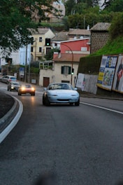 A friendly instructor guiding a student through a driving lesson in a suburban neighborhood.