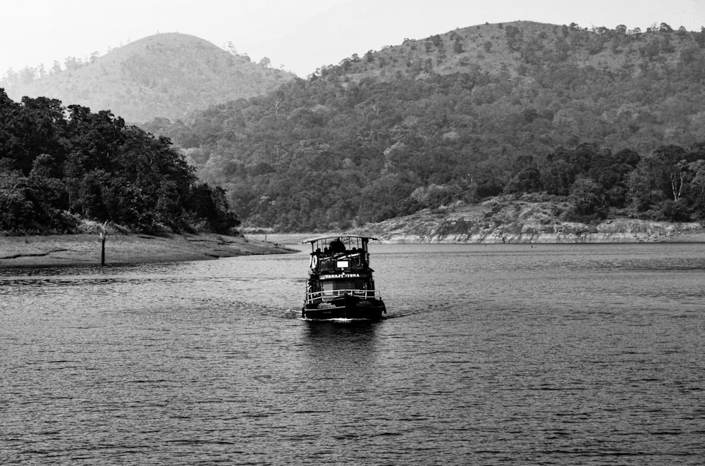 grayscale photo of boat on river