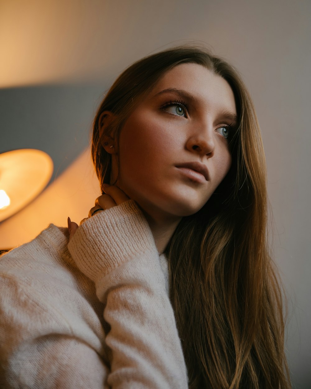 woman in white sweater sitting on chair