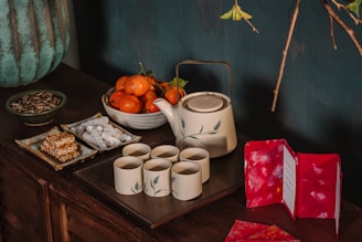 white ceramic mugs on brown wooden table